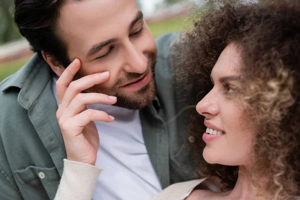 Two people leaning in across a table, clearly absorbed in each other